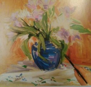 hand with paintbrush adding details to a painting of a vase with flowers