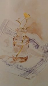 glass jar with flowers on a white and blue table cloth painted with watercolors