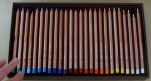 Open box of Caran D'Ache colored pencils