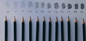 several graphite pencils on a tone chart