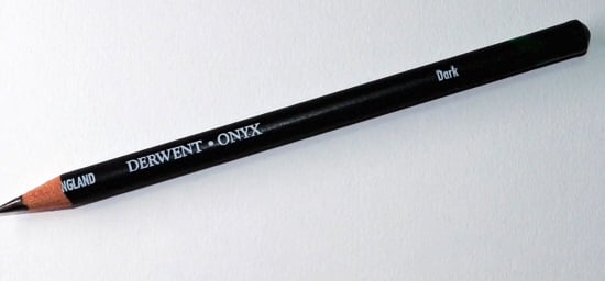 single onyx derwent graphite pencil on a white surface